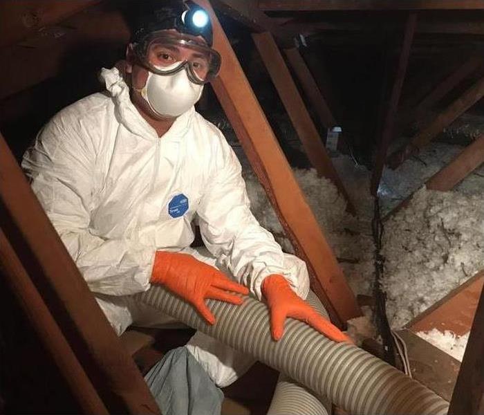 Technician drying up attic